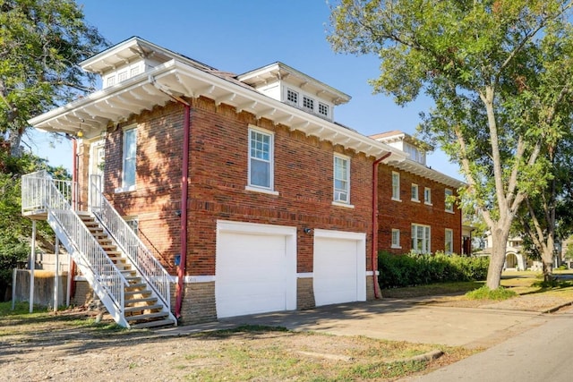 517 N 9th St, Temple, TX 76501 - view of property exterior with a garage, brick siding, driveway, and stairs
