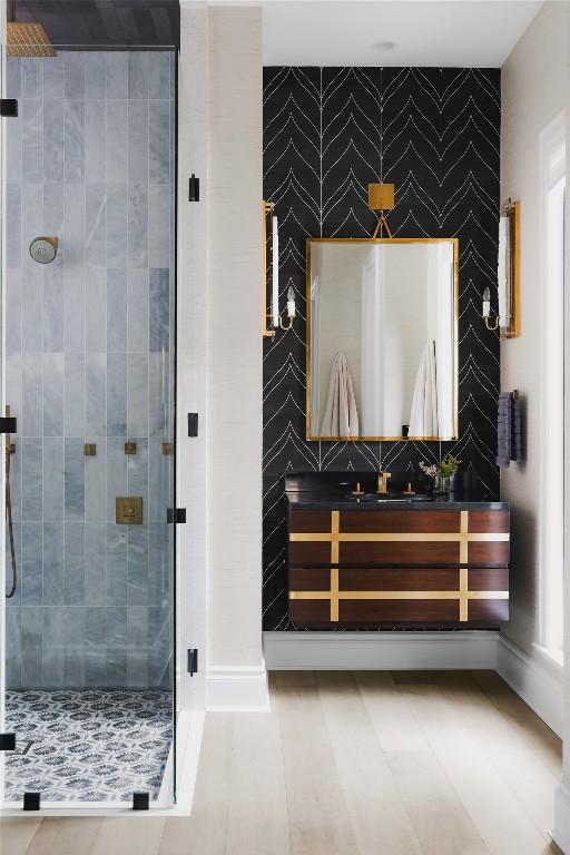 901 Wayside Dr, Austin, TX 78703 - bathroom featuring vanity, a shower stall, baseboards, and an accent wall