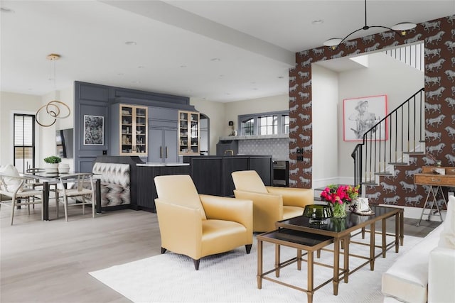 901 Wayside Dr, Austin, TX 78703 - living room with light wood-style flooring, wallpapered walls, and stairway
