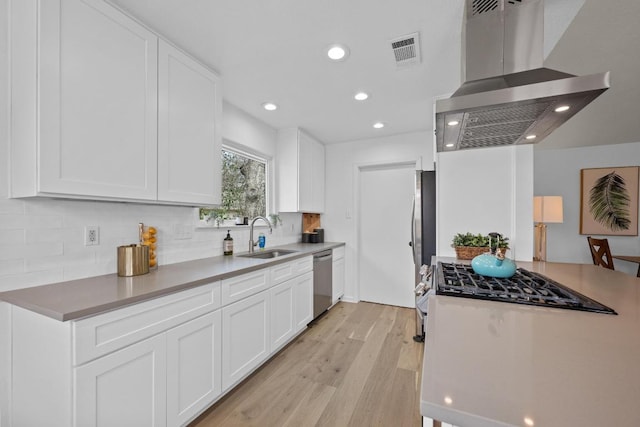 11305 Songbird Cv, Austin, TX 78750 - kitchen featuring extractor fan, stainless steel dishwasher, light wood-style floors, tasteful backsplash, and recessed lighting