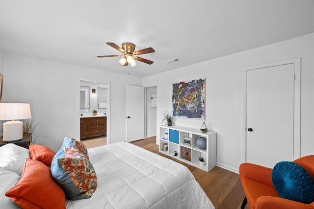 11305 Songbird Cv, Austin, TX 78750 - bedroom with light wood-style flooring, connected bathroom, and ceiling fan