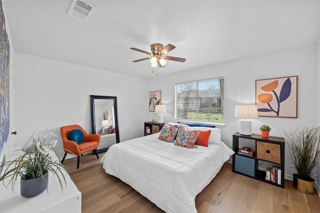 11305 Songbird Cv, Austin, TX 78750 - bedroom featuring wood finished floors and a ceiling fan