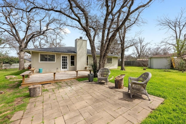 11305 Songbird Cv, Austin, TX 78750 - fenced backyard with a patio, a deck, and a storage unit