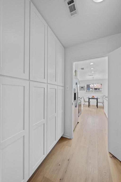 11305 Songbird Cv, Austin, TX 78750 - hallway with light wood-style floors
