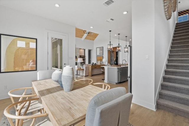 100 Silent Grove Ct, Georgetown, TX 78642 - dining room with light wood finished floors, stairs, recessed lighting, and vaulted ceiling
