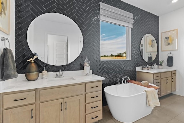100 Silent Grove Ct, Georgetown, TX 78642 - bathroom featuring an accent wall, two vanities, a soaking tub, tile patterned floors, and tile walls