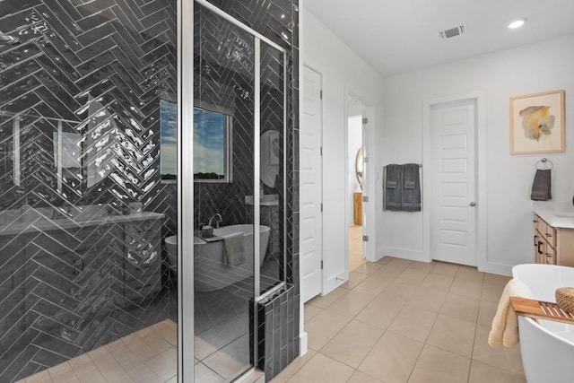 100 Silent Grove Ct, Georgetown, TX 78642 - full bathroom with vanity, a freestanding tub, a stall shower, tile patterned floors, and recessed lighting