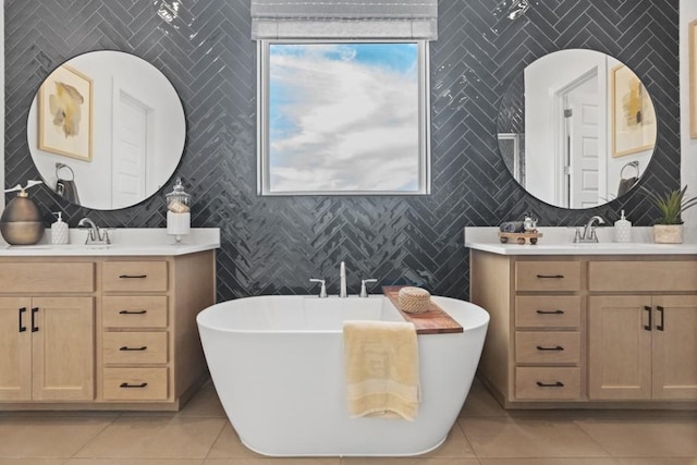 100 Silent Grove Ct, Georgetown, TX 78642 - full bathroom with tile patterned floors, two vanities, tile walls, and a freestanding bath