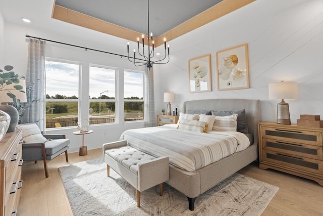 100 Silent Grove Ct, Georgetown, TX 78642 - bedroom featuring light wood-style floors, a chandelier, and recessed lighting