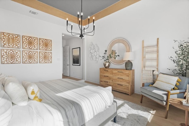 100 Silent Grove Ct, Georgetown, TX 78642 - bedroom with wood finished floors and a chandelier