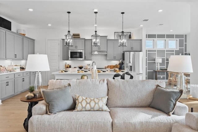 100 Silent Grove Ct, Georgetown, TX 78642 - living room with light wood-type flooring, recessed lighting, and a chandelier