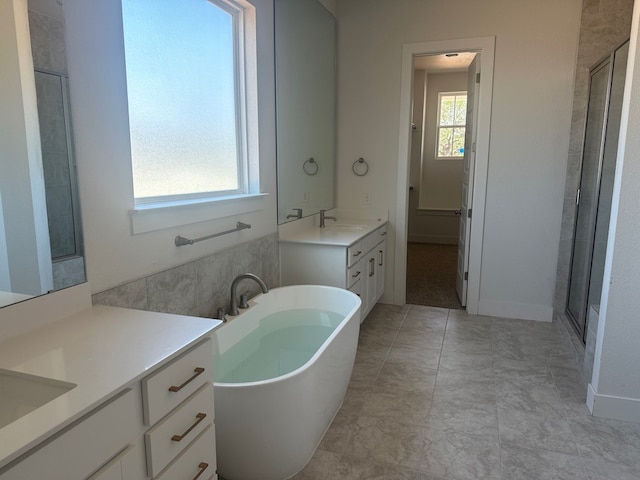 100 Silent Grove Ct, Georgetown, TX 78642 - bathroom with two vanities, a freestanding bath, and a shower stall