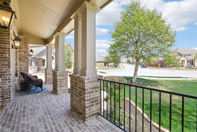 view of patio featuring a residential view and a porch