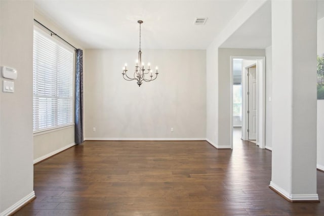 interior space with a notable chandelier, visible vents, dark wood-style floors, and a wealth of natural light
