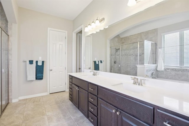 3036 Margarita Loop, Round Rock, TX 78665 - bathroom with a stall shower, double vanity, and tile patterned floors