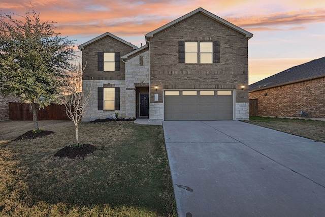 traditional-style house featuring a front yard, an attached garage, stone siding, fence, and driveway