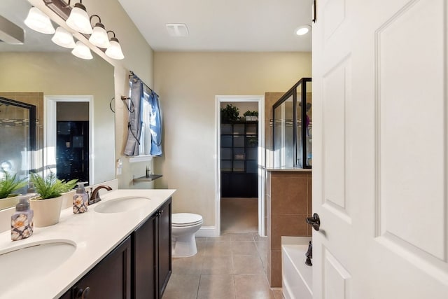 bathroom with tile patterned floors, a shower with door, and a sink