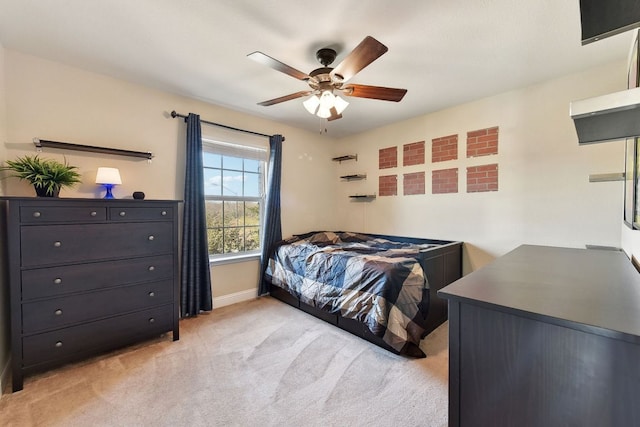 bedroom with light carpet, a ceiling fan, and baseboards