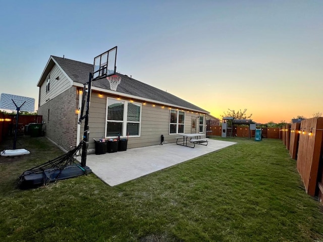 rear view of property with a fenced backyard, a playground, a patio area, and a lawn