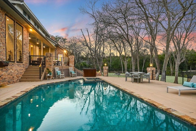 504 Konstanty Cir, Austin, TX 78746 - pool at dusk with stairway, a deck, and a pool with connected hot tub