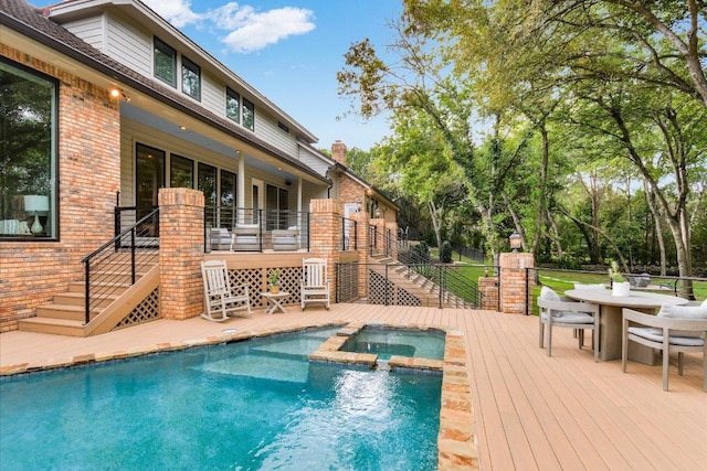 504 Konstanty Cir, Austin, TX 78746 - view of pool with stairway, a pool with connected hot tub, a wooden deck, and outdoor dining area