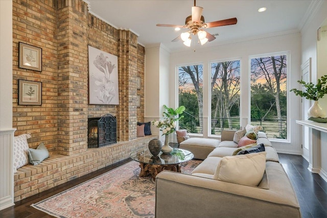 504 Konstanty Cir, Austin, TX 78746 - living room featuring a brick fireplace, dark wood finished floors, ceiling fan, and crown molding