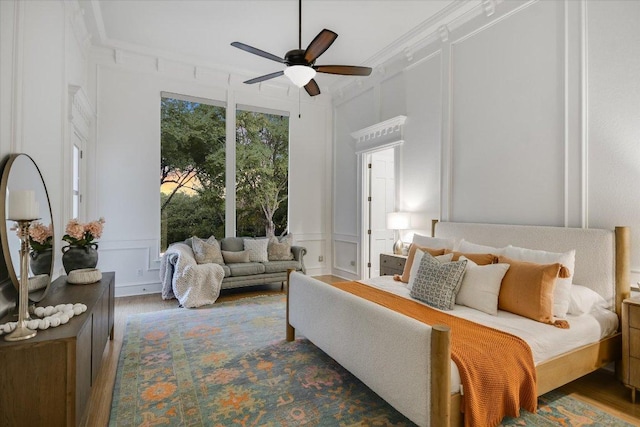 504 Konstanty Cir, Austin, TX 78746 - bedroom with a decorative wall, wood finished floors, and ceiling fan