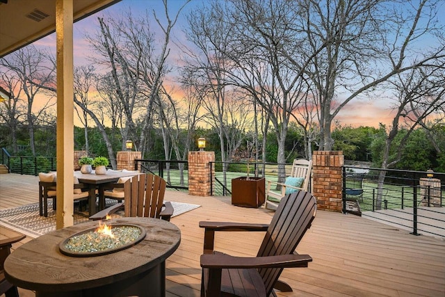 504 Konstanty Cir, Austin, TX 78746 - deck at dusk with an outdoor fire pit and outdoor dining space