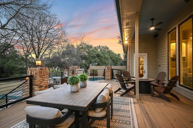 504 Konstanty Cir, Austin, TX 78746 - deck at dusk with an outdoor fire pit and outdoor dining area