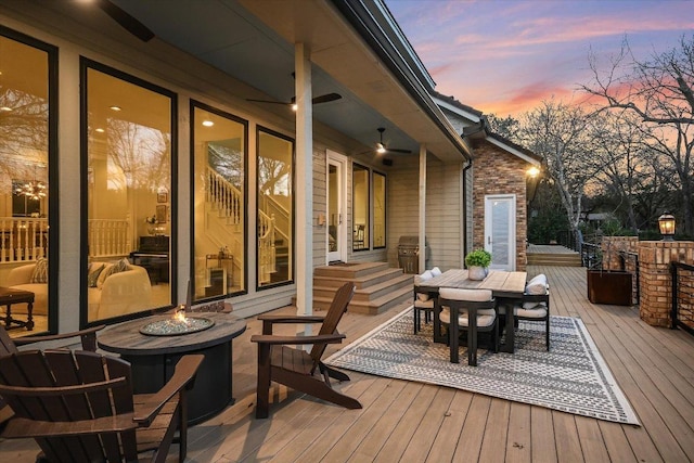 504 Konstanty Cir, Austin, TX 78746 - deck at dusk featuring a fire pit, outdoor dining space, and grilling area