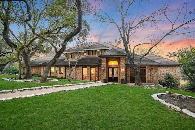504 Konstanty Cir, Austin, TX 78746 - view of front of home with a yard and brick siding