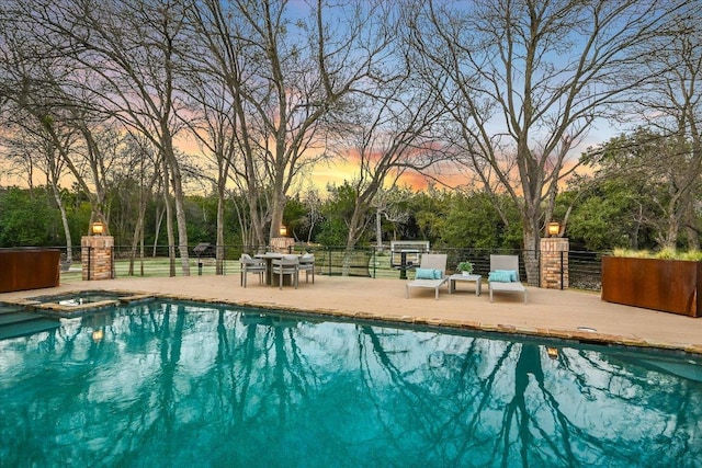 504 Konstanty Cir, Austin, TX 78746 - pool at dusk featuring a pool with connected hot tub