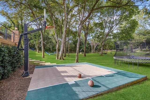 504 Konstanty Cir, Austin, TX 78746 - view of basketball court featuring a trampoline, a lawn, and basketball court