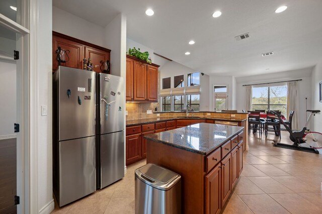 kitchen with a sink, light tile patterned flooring, and visible vents