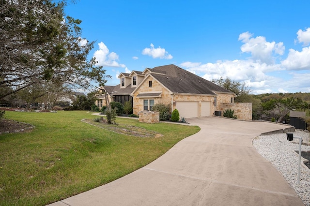 view of front facade featuring concrete driveway, stone siding, a front yard, a garage, and a shingled roof