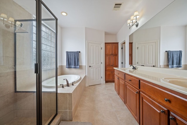 bathroom with a sink, a garden tub, tile patterned flooring, and a shower stall