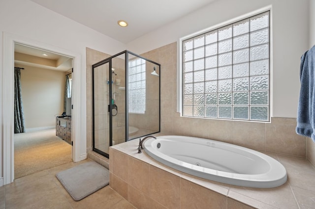 bathroom with recessed lighting, a garden tub, tile patterned floors, and a shower stall