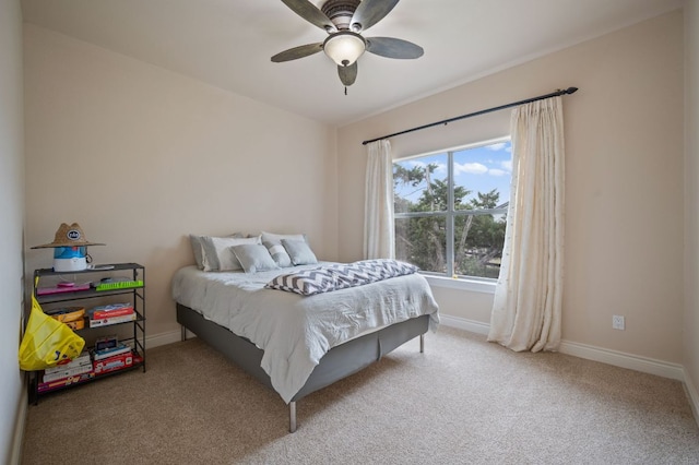 carpeted bedroom with baseboards and ceiling fan