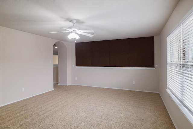 19803 Mallard Pond Trl, Pflugerville, TX 78660 - empty room featuring carpet floors, a ceiling fan, and arched walkways