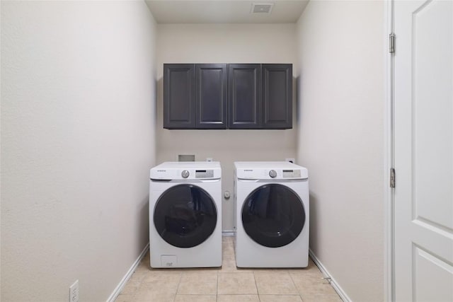 19803 Mallard Pond Trl, Pflugerville, TX 78660 - laundry room with cabinet space, washing machine and clothes dryer, and light tile patterned floors