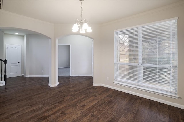 19803 Mallard Pond Trl, Pflugerville, TX 78660 - unfurnished dining area featuring arched walkways, a chandelier, dark wood-style flooring, and crown molding