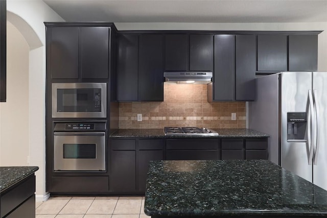 19803 Mallard Pond Trl, Pflugerville, TX 78660 - kitchen with appliances with stainless steel finishes, under cabinet range hood, arched walkways, and backsplash