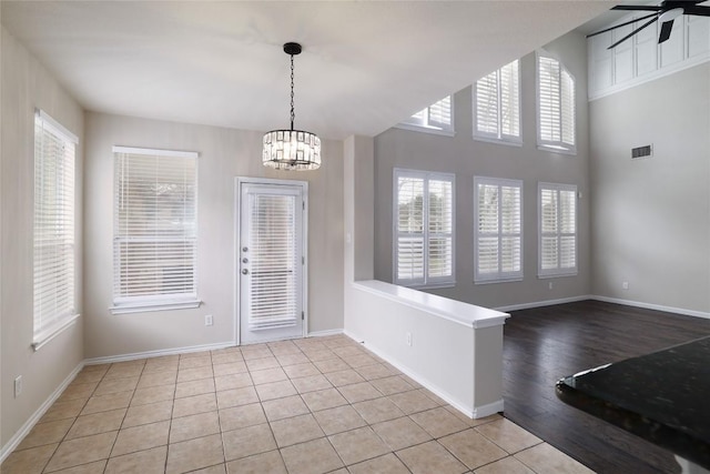 19803 Mallard Pond Trl, Pflugerville, TX 78660 - unfurnished dining area with a chandelier, a ceiling fan, and tile patterned flooring