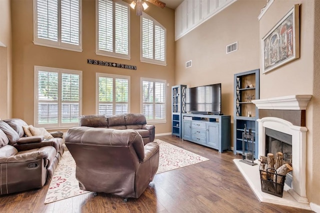 19803 Mallard Pond Trl, Pflugerville, TX 78660 - living room with a towering ceiling, ceiling fan, wood finished floors, and a fireplace with raised hearth