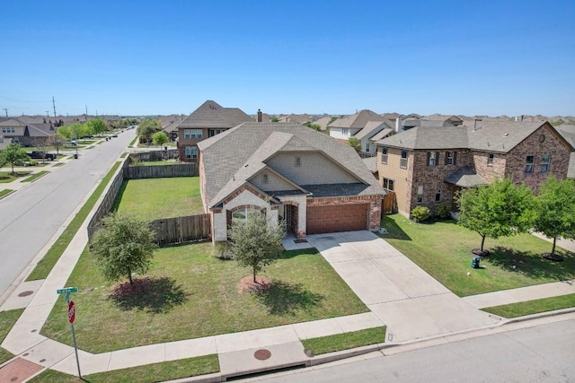 view of front facade with driveway, a residential view, a garage, brick siding, and a front lawn