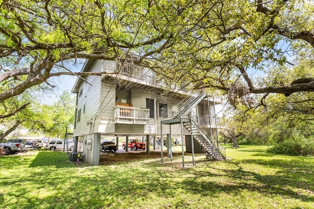5306 Indio Cv, Austin, TX 78745 - rear view of house with stairs, a lawn, and central AC