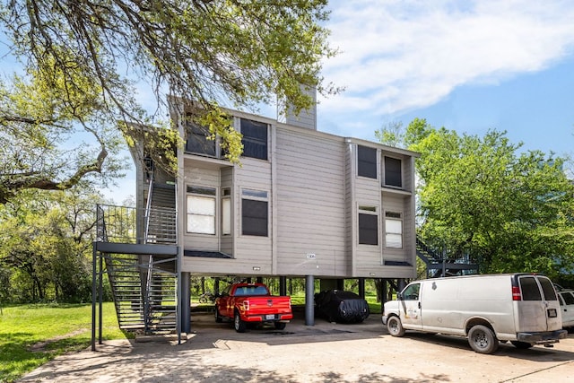 5306 Indio Cv, Austin, TX 78745 - view of building exterior with stairs, a carport, and concrete driveway