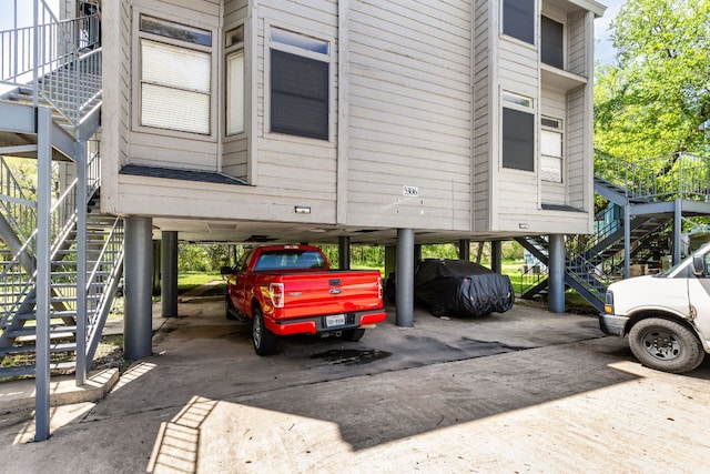 5306 Indio Cv, Austin, TX 78745 - view of vehicle parking with stairway, a carport, and driveway