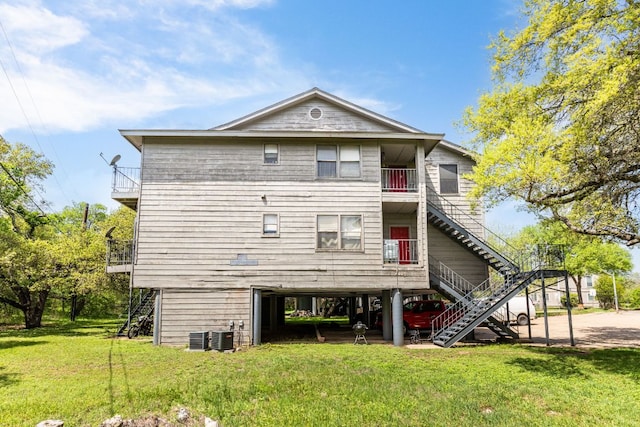 5306 Indio Cv, Austin, TX 78745 - back of house featuring stairs, a lawn, a balcony, and central AC unit