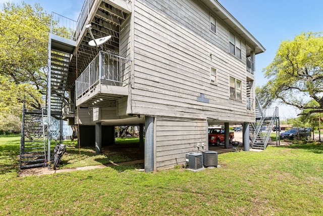 5306 Indio Cv, Austin, TX 78745 - view of side of property featuring stairs, a yard, and central AC